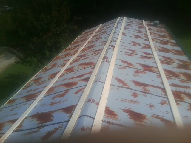 Rusted metal roof panels with new wood purlins before replacement — Storm Damage Roof Repair in Biddeford Pool by Roofing Brothers