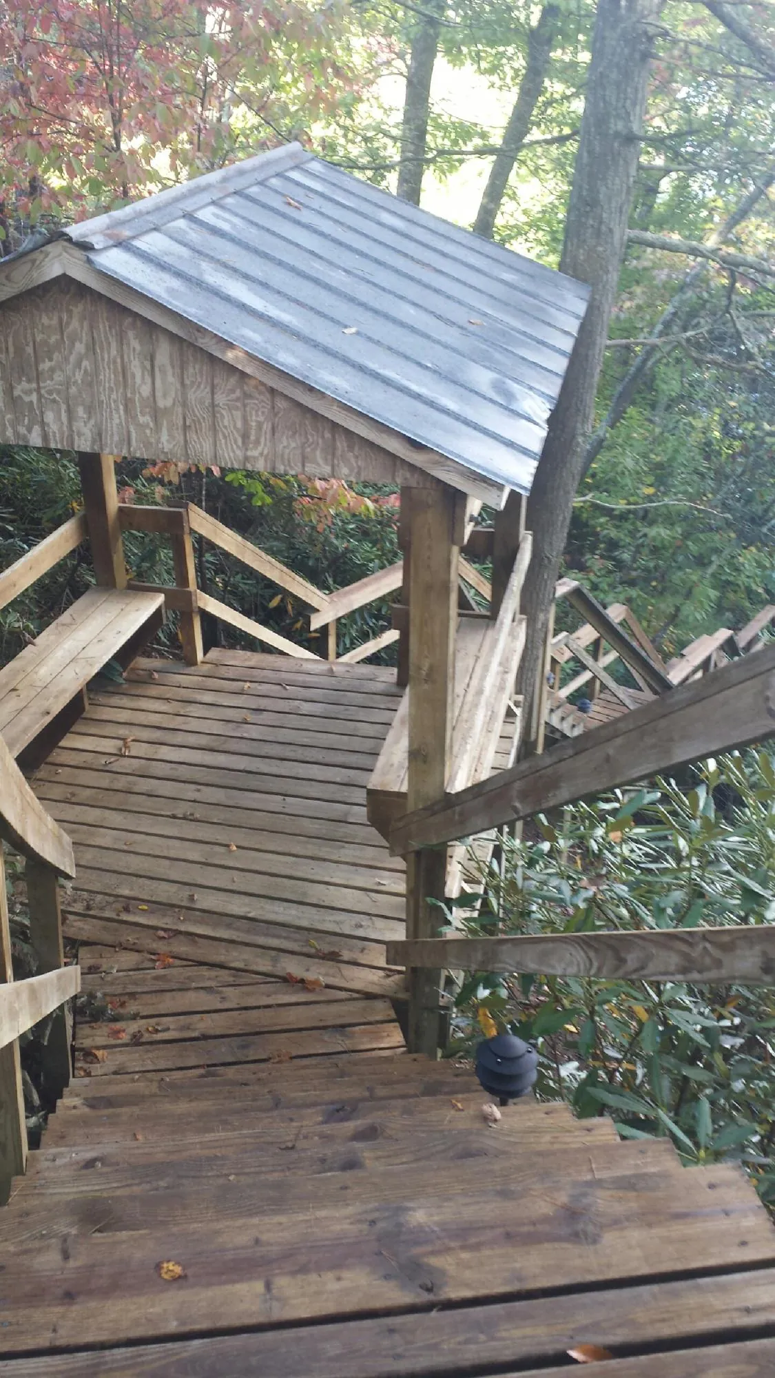 Metal roofed shelter over wooden steps on a wooded walkway — Skylight Repair & Installation work by our crew in Biddeford Pool